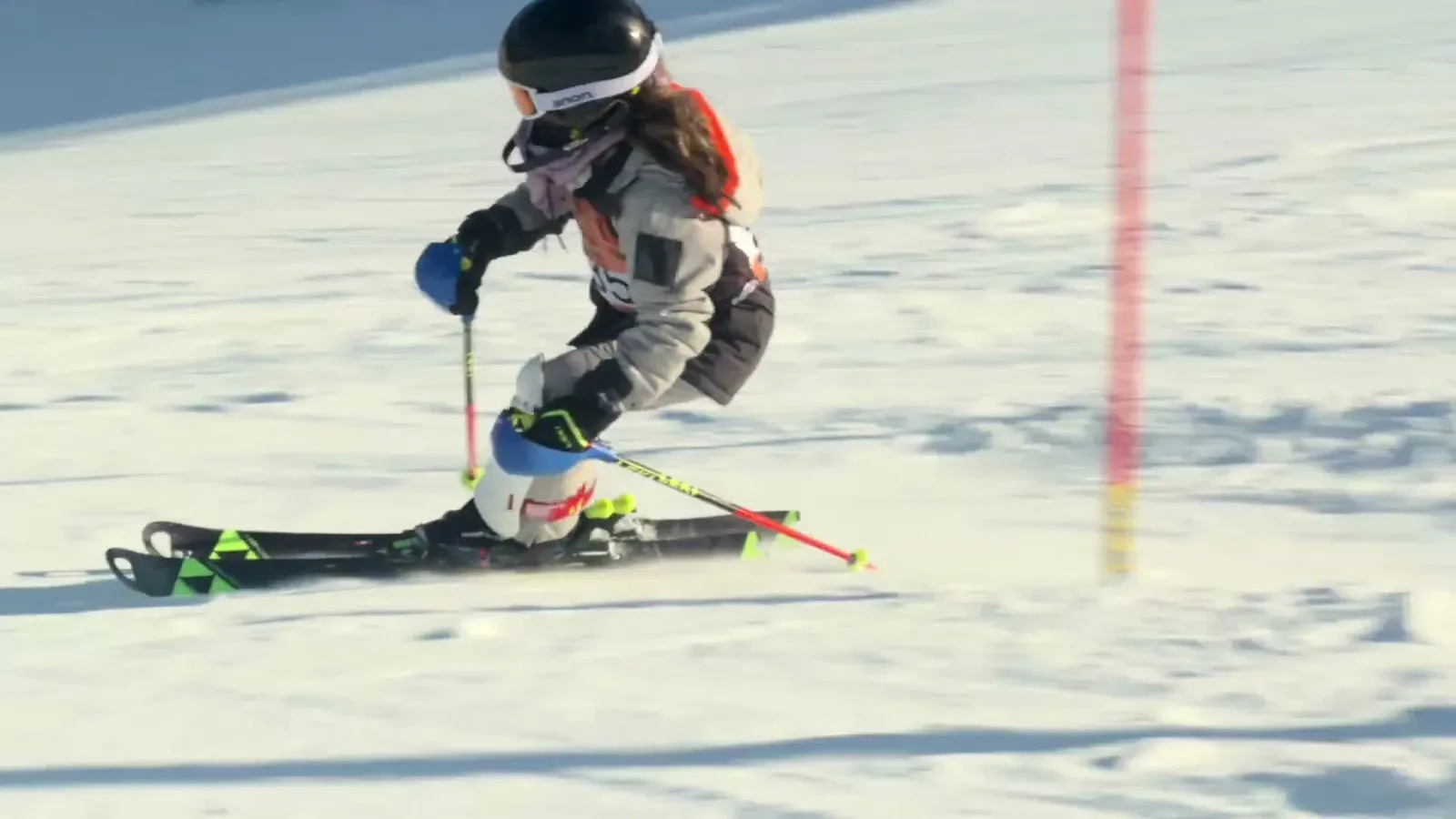 A racer carves past a slalom gate