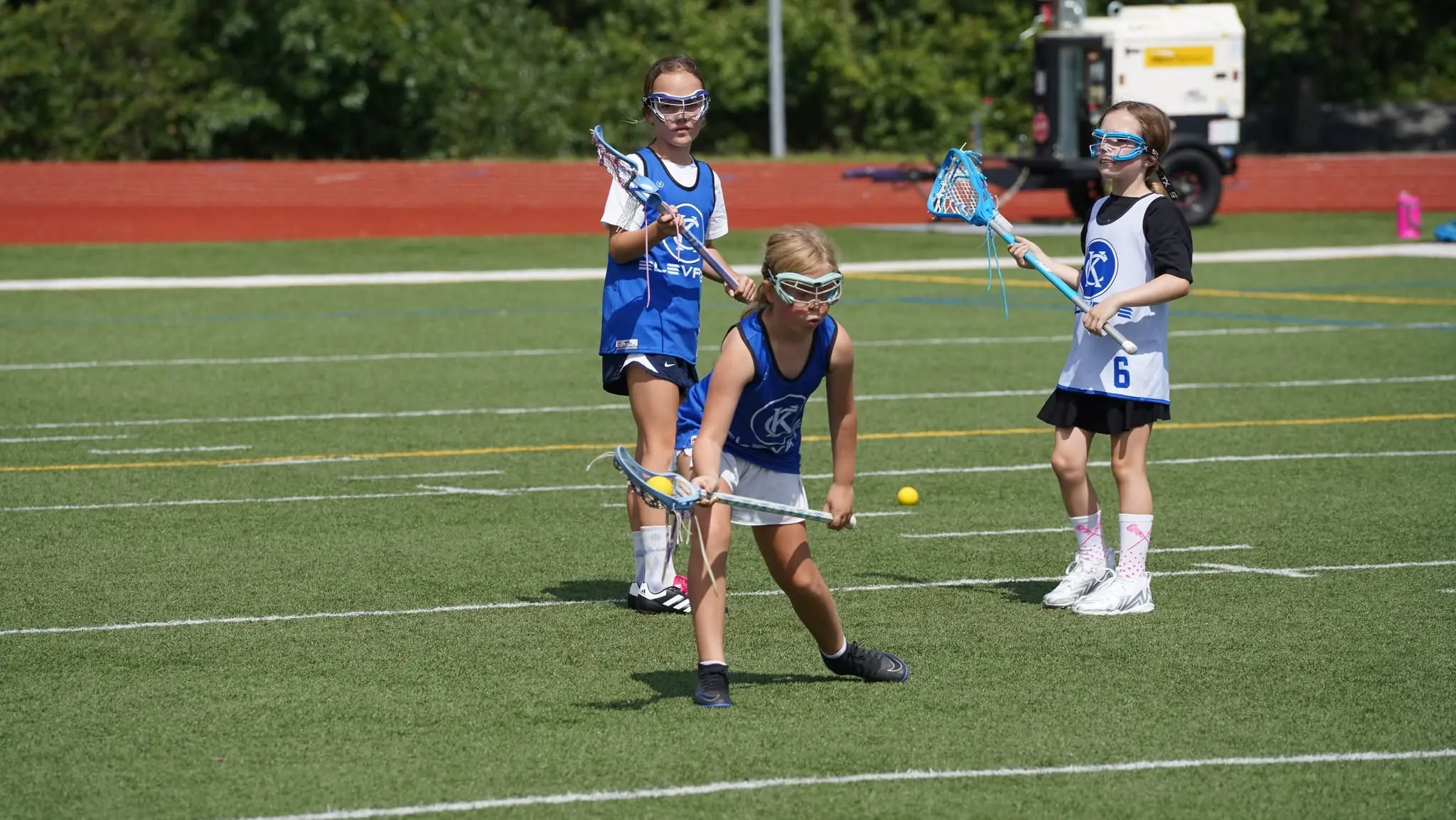 Young KC Elevate players in Elevate pinnies learning to play