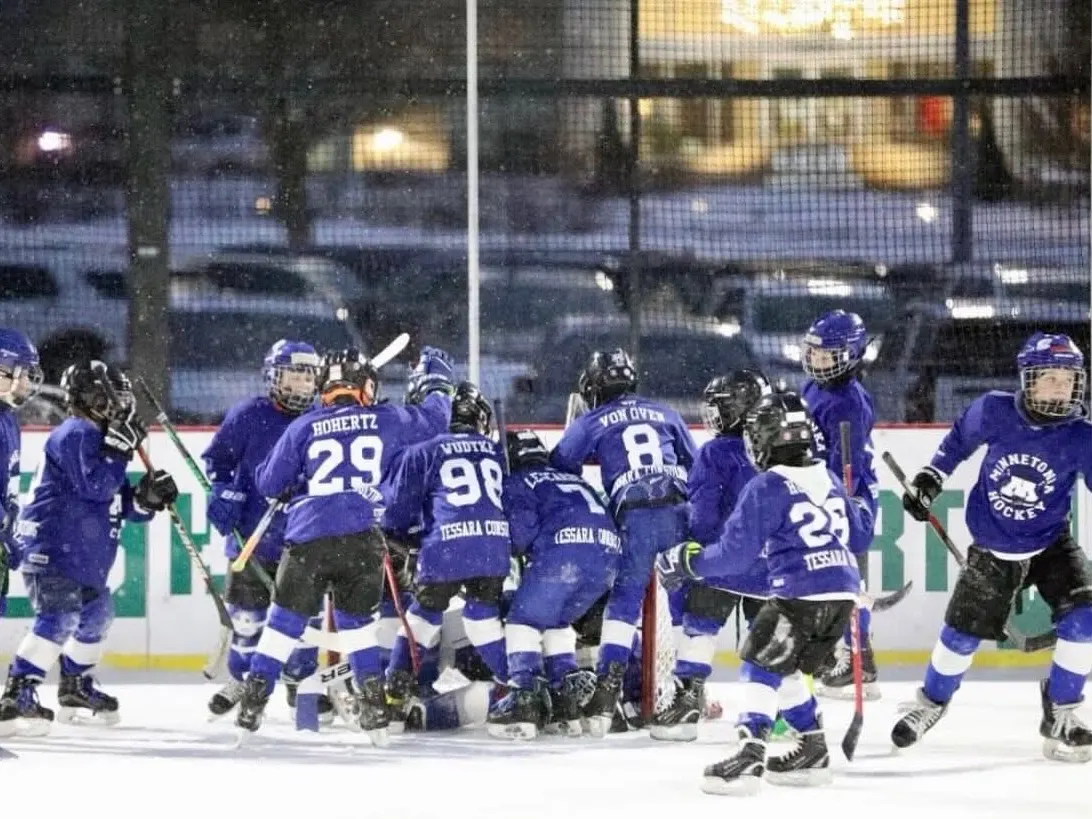 Minnetonka mites celebrating together on an outdoor rink