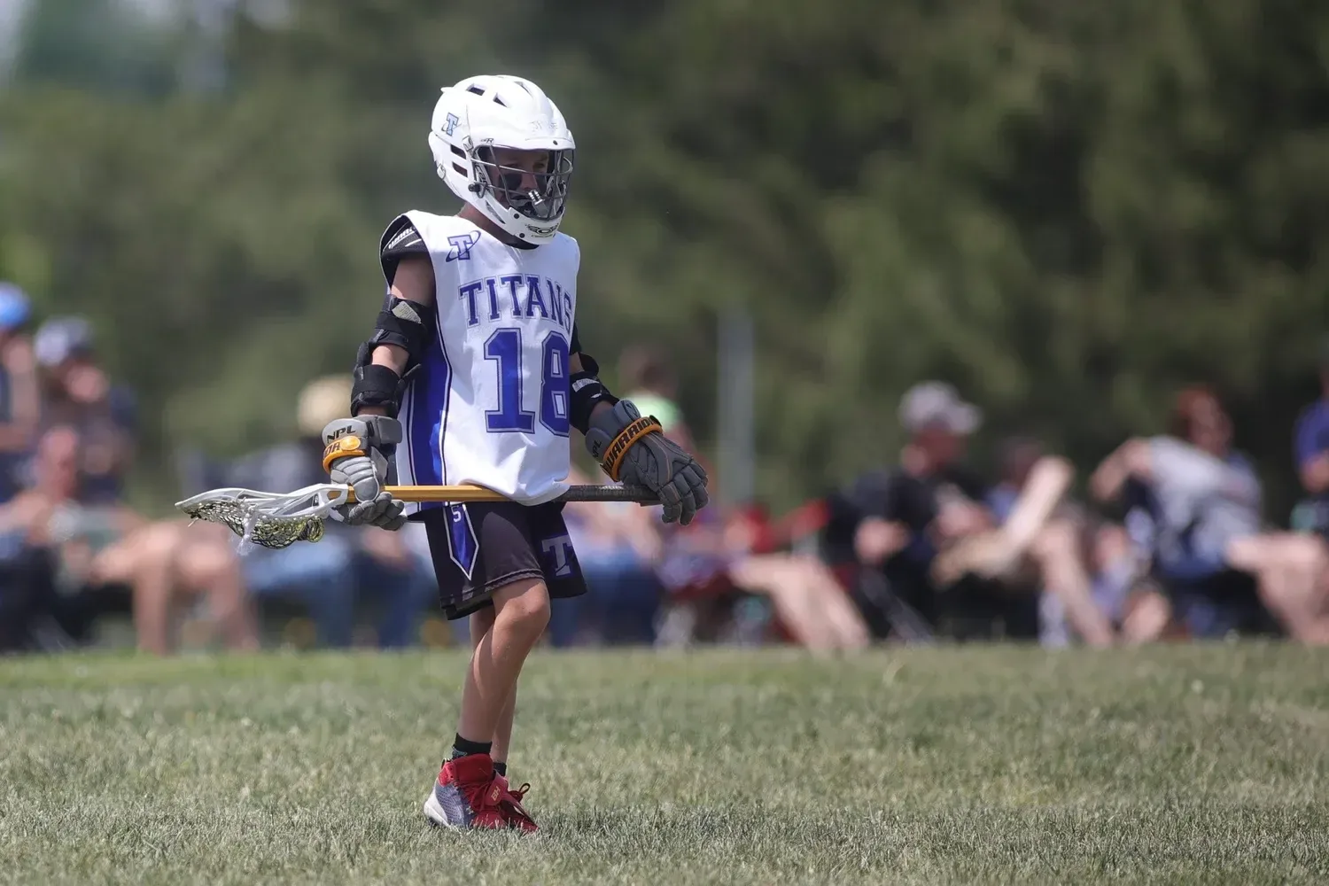 An Omaha Lacrosse Club player cradling the ball in a game