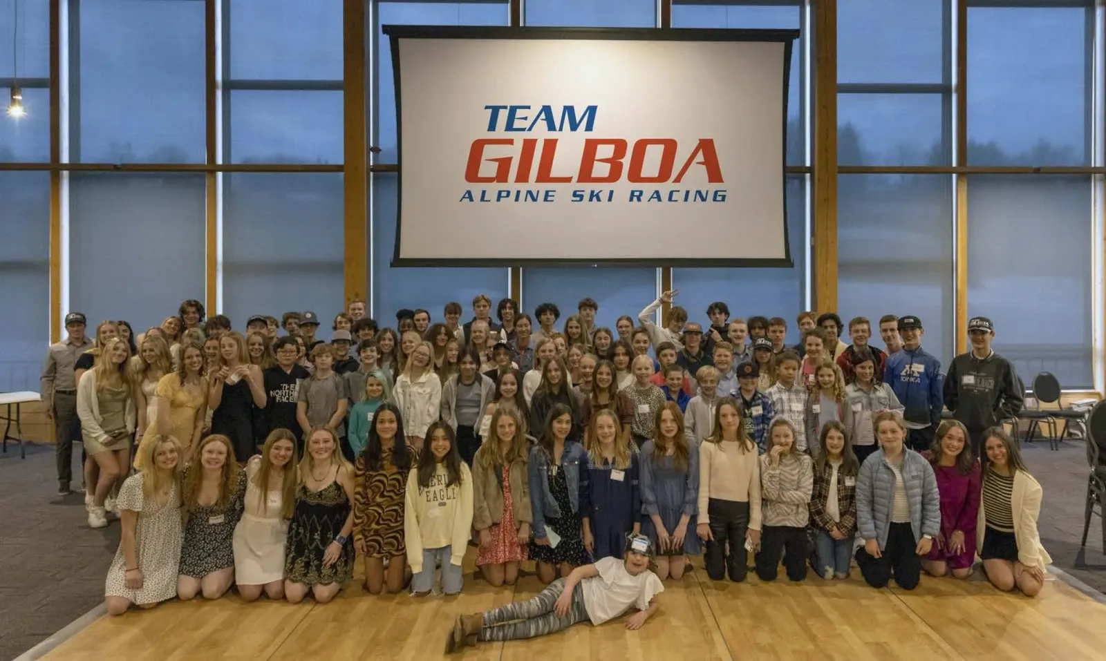 The Team Gilboa community gathered in front of the club banner
