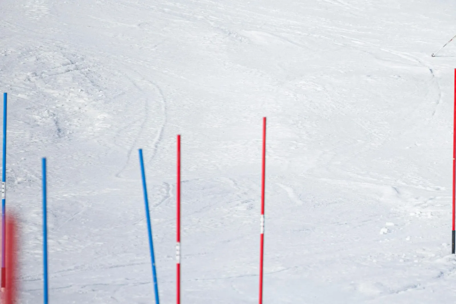 Red and blue slalom gates on a groomed race hill