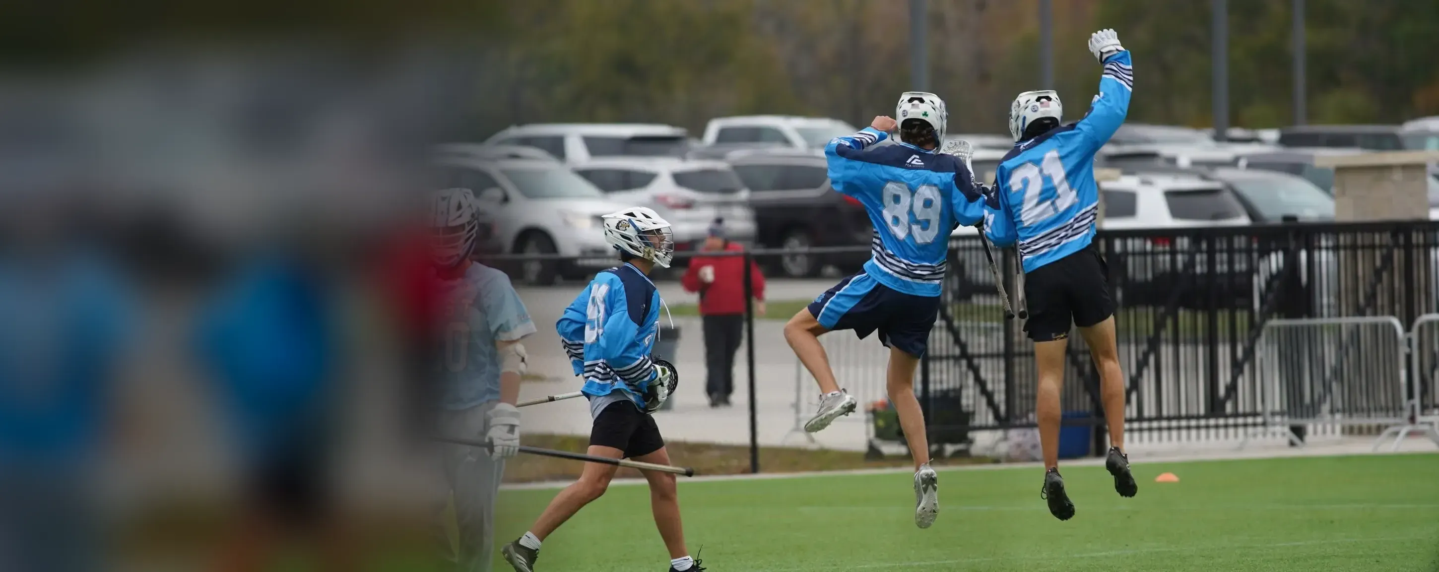 Two high school players jump to celebrate a goal