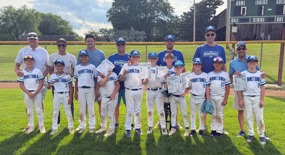 An MBA 10AA team in white with its coaches