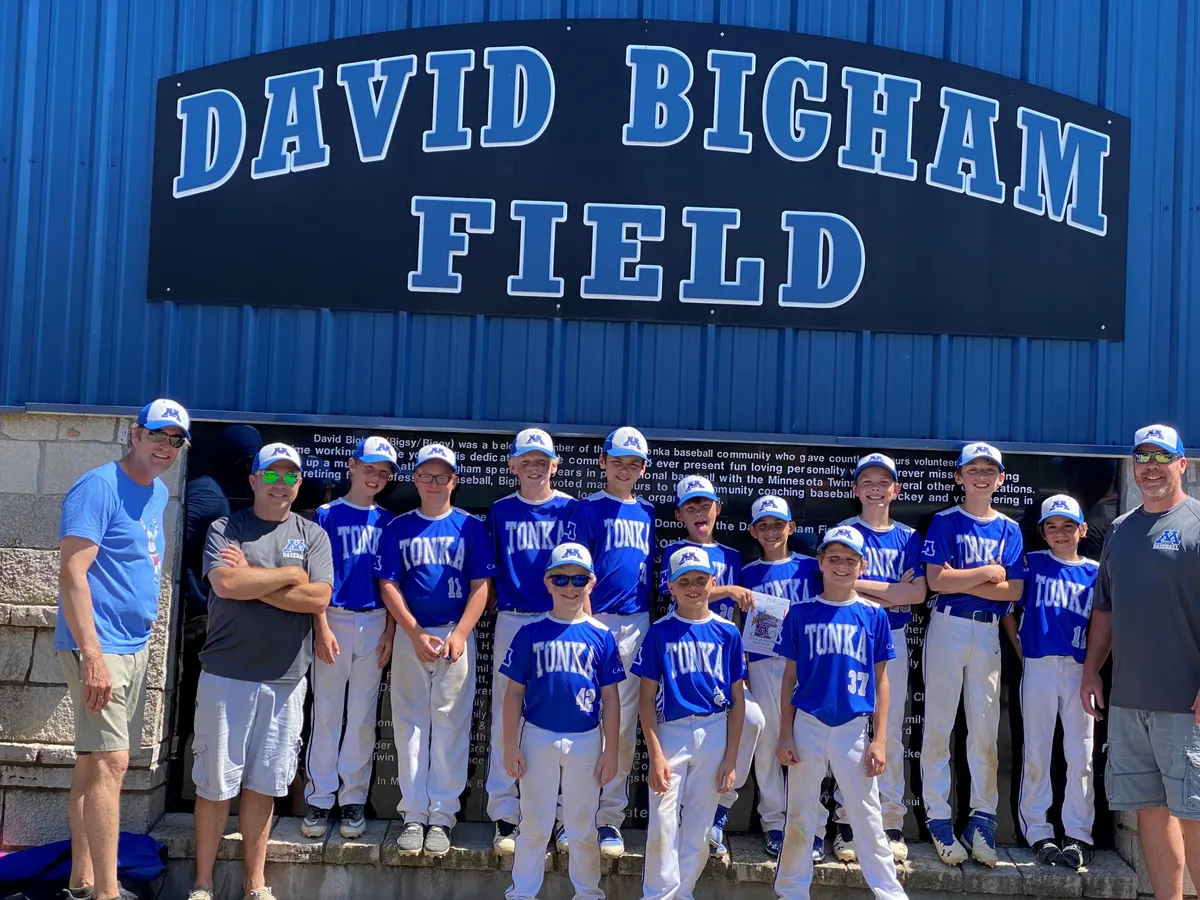 An MBA 10A Blue team under the David Bigham Field sign